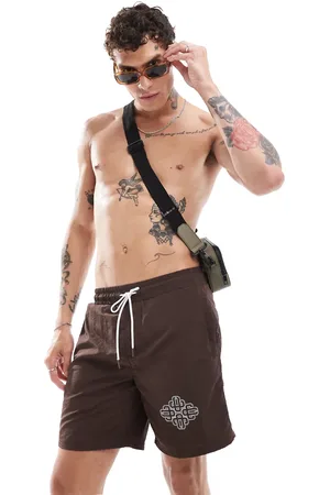 The Couture Club Script print swim shorts in
