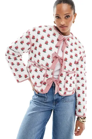 The Frolic Exclusive quilted bow tie front reversible jacket in cream floral and red stripe