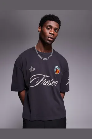 ASOS Boxy oversized washed t-shirt with sports graphic and badge in