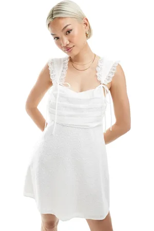The Frolic Exclusive lace trim ruched bust bow detail mini dress in