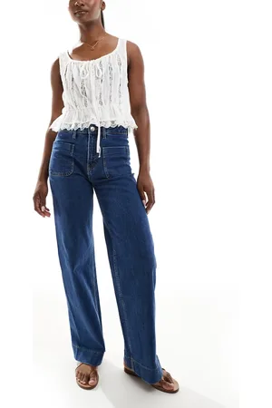 Bershka High waisted pocket detail jeans in mid wash