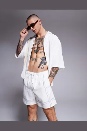 ASOS Swim shorts in mid length in stone with border print