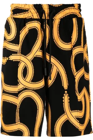 MARCELO BURLON Snakes print track shorts