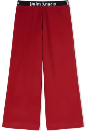 PALM ANGELS: jogging trousers with all over logo - Red