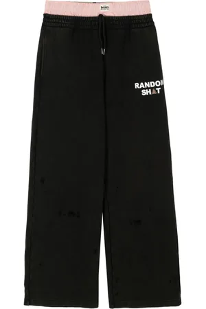 Natasha Zinko Layered logo-print trousers