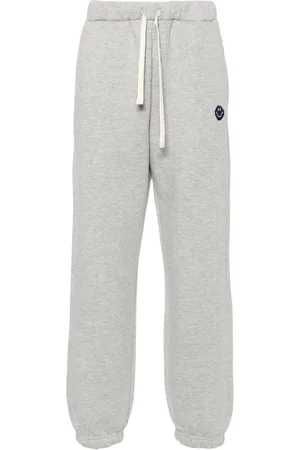 JOSHUA SANDERS Smiley face-embroidered track pants
