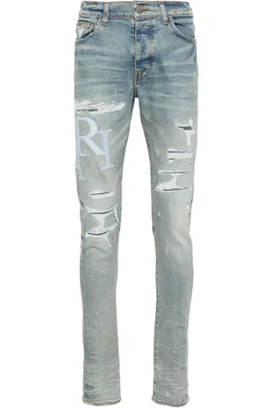 AMIRI Staggered-logo skinny jeans