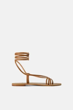 Zara Flat leather sandals with wide crisscross straps. Metal studs